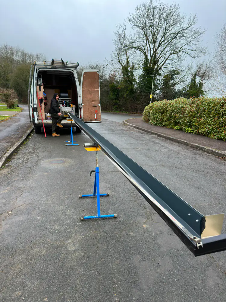 Long seamless gutter being formed beside the Gutterworx van
